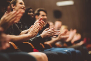 Happy audience applauding